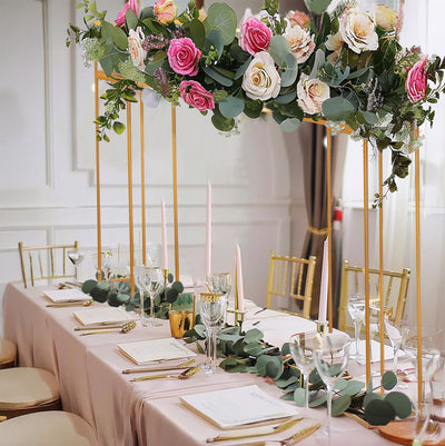 Elegant wedding table setting with floral centerpiece and gold accents.