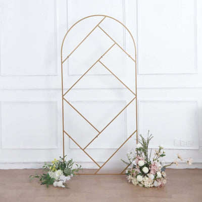 Gold geometric arch display with floral arrangements