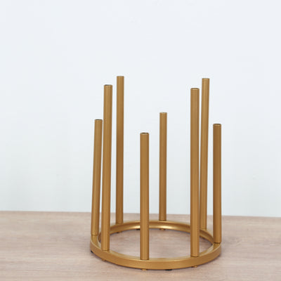 Gold metal plant stand with tall, slender legs.