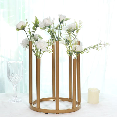 Gold flower vase holder with white roses and greenery, elegant decor piece.