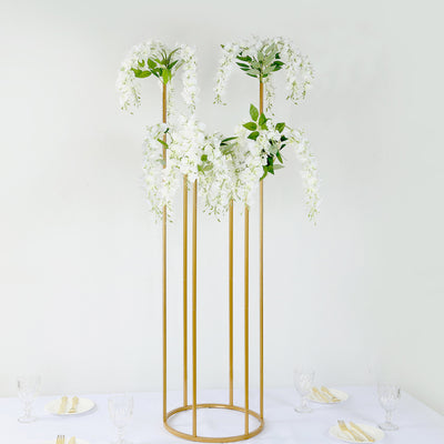 Elegant white floral arrangement on a gold stand for events or decor.