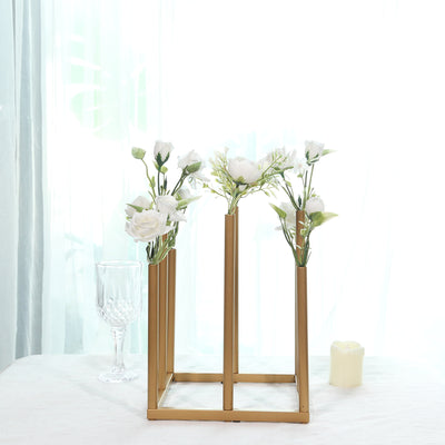 Gold flower vase with white blooms on a table in a bright setting.
