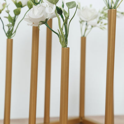 Gold flower vase holder with white artificial flowers