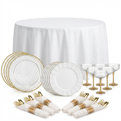 Elegant dining set with gold accents on a white tablecloth.