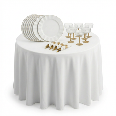 Elegant dinnerware set with plates and glassware on a round table