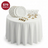 Elegant dining set with white plates and glassware on a round table
