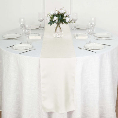 Elegant table setting with a floral centerpiece and linen table runner.