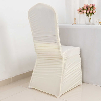 Cream chair cover draped elegantly over a chair in a bright setting.