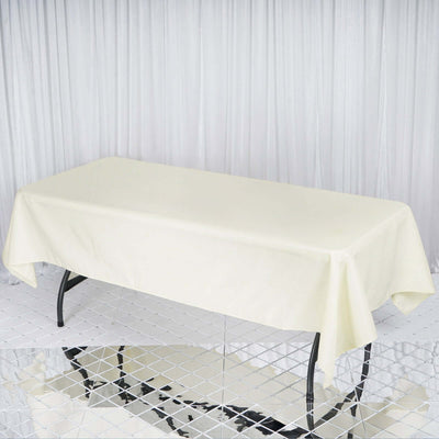 Cream tablecloth draped over a table in a studio setting.