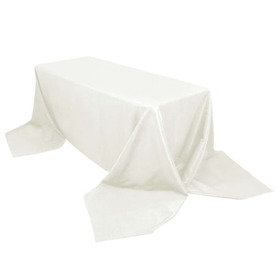 White satin tablecloth draped elegantly over a rectangular table