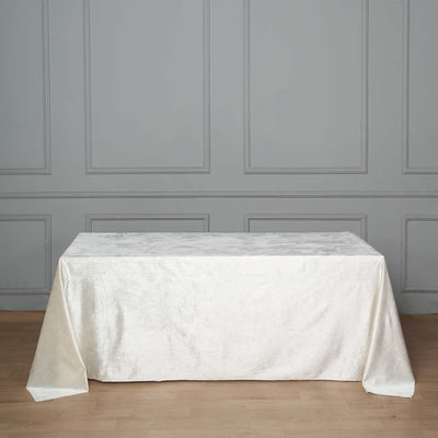 White textured tablecloth draped over a table in a stylish interior setting.