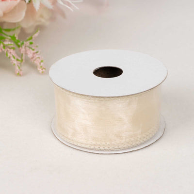 Cream satin ribbon roll on a white background