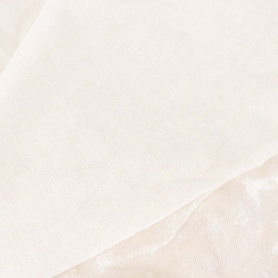 Textured white fabric close-up showing soft, lightweight material details.