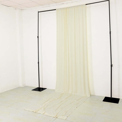 Cream backdrop fabric draped on a support stand for photography setups.