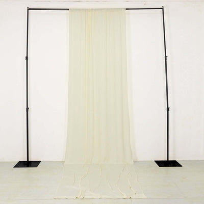 Cream drapery fabric on a black metal stand against a plain background.