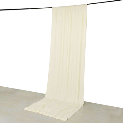 Cream fabric drapery hanging from a rod against a white backdrop