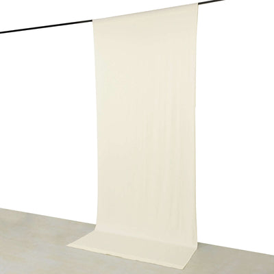 Cream backdrop fabric hanging on a rod for photography or staging purposes.
