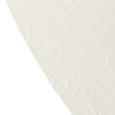 Wrinkled cream fabric on a plain background