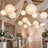 Elegant wedding reception with paper lanterns, draped fabric, and floral tablescapes