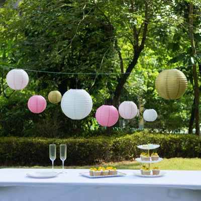 Colorful paper lanterns hanging outdoors at a festive gathering.