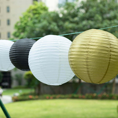 Colorful paper lanterns hanging outdoors in a garden setting.