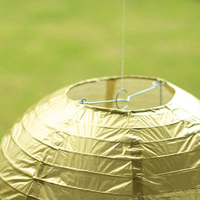 Gold paper lantern with a hanging hook for decorations.