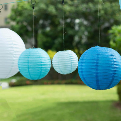 Hanging blue and white paper lanterns in a garden setting.