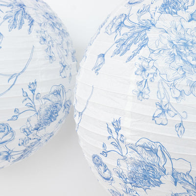 Blue floral patterned paper lanterns on a white background