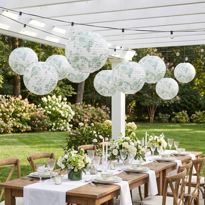 Elegant outdoor dinner party setup with floral lanterns and garden table decor