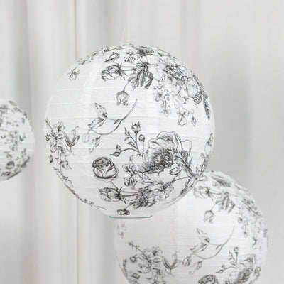 Floral paper lanterns in black and white design hanging decoratively.