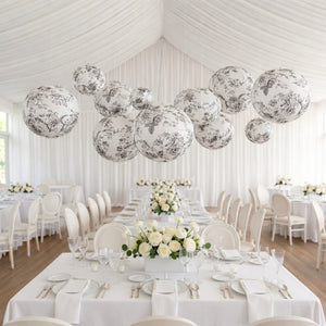 Elegant floral paper lanterns hanging above a beautifully arranged dining area.