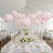 Decorative pink floral lanterns suspended over an elegant dining setup.