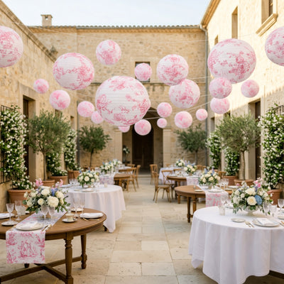 Elegant outdoor wedding setup with floral decorations and hanging lanterns.