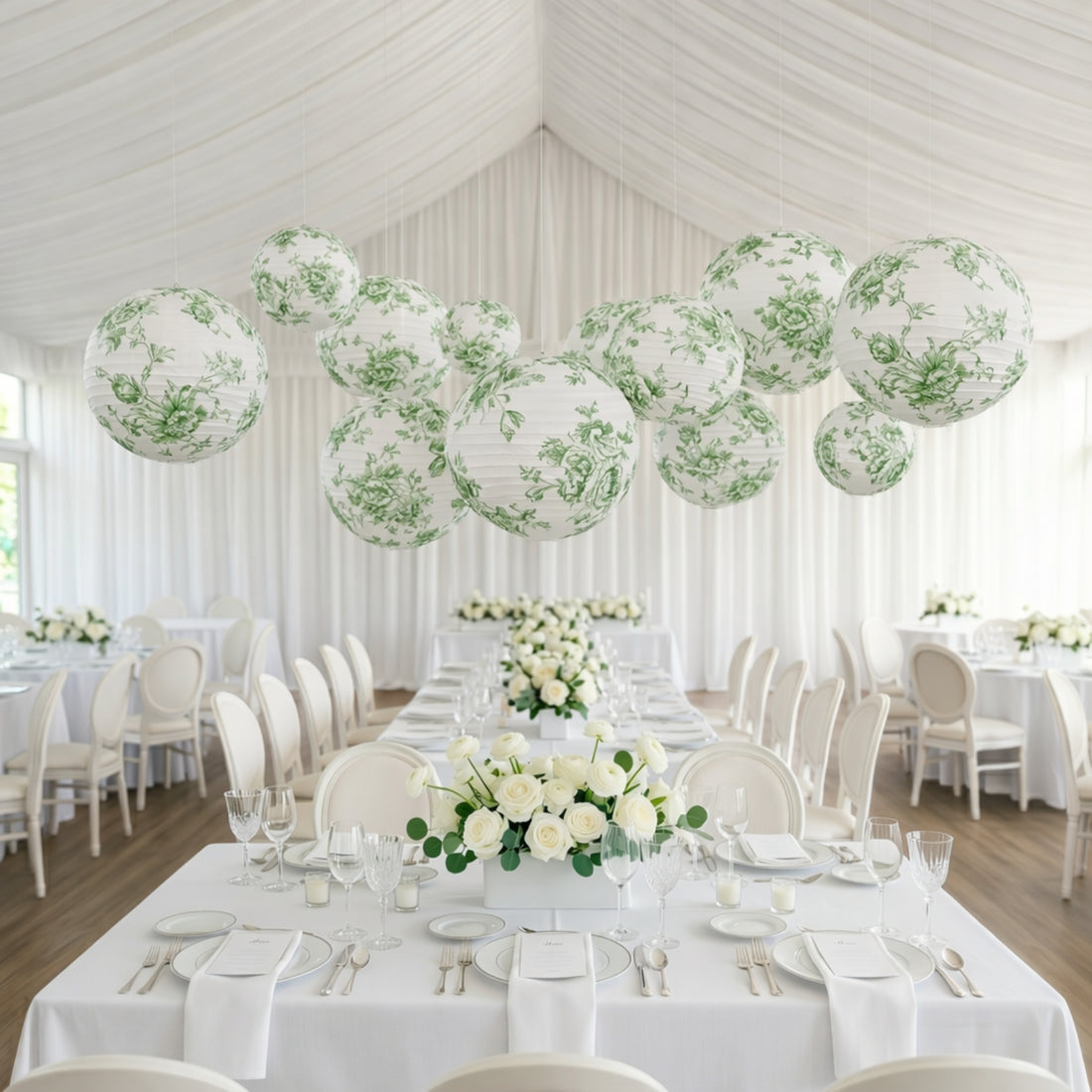 Elegant green floral lanterns suspended above a beautifully decorated dining table.