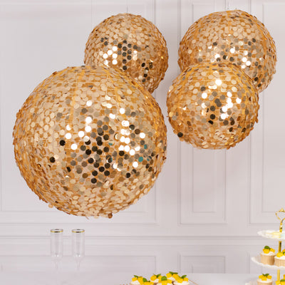 Gold sequin disco balls hanging as decorative accents