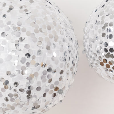 Silver sequin disco balls reflecting light, adding sparkle to any event.