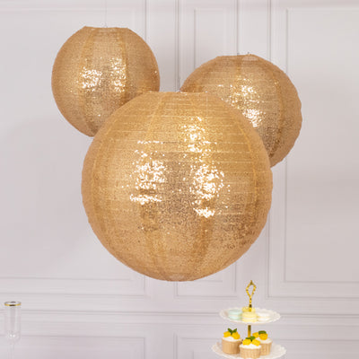 Gold sequin lanterns hanging above a dessert stand with cupcakes.