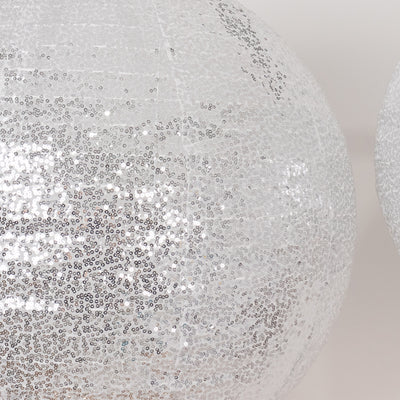 Silver sequined disco ball, reflecting light and adding sparkle to any event.