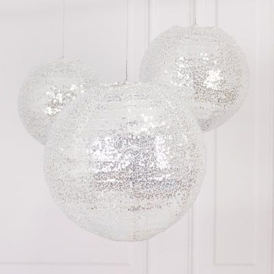 Silver sequin hanging lanterns in various sizes against a white background