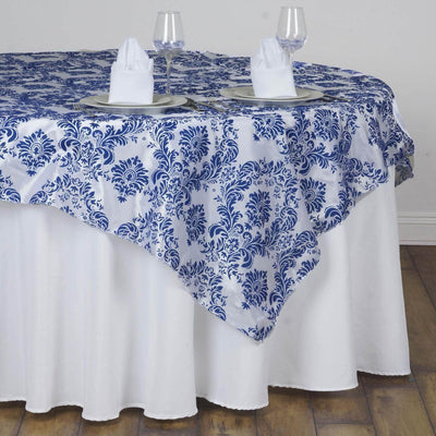Elegant blue and white patterned tablecloth on a dining table setting.