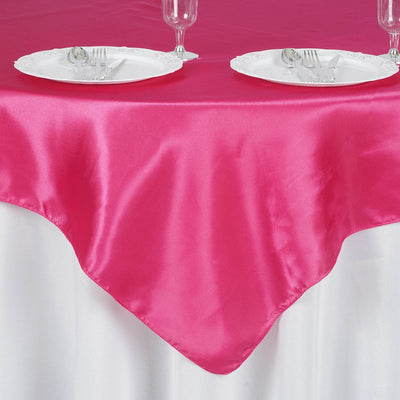 Pink satin tablecloth draped elegantly over a white table.