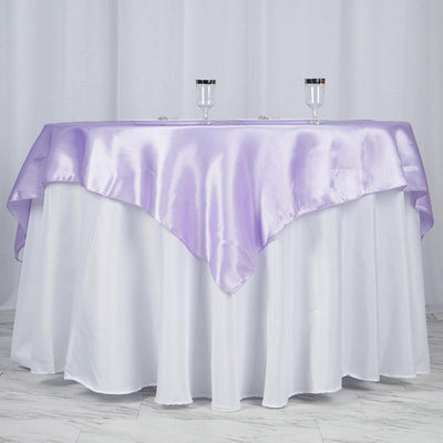 Purple satin table overlay on a white tablecloth with glasses