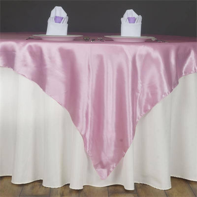 Pink satin tablecloth draped elegantly over a white table.