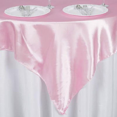 Pink satin tablecloth draped elegantly over a white table.