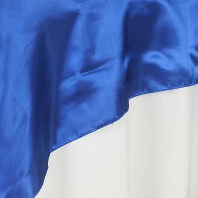Blue satin fabric draped elegantly on a white backdrop.