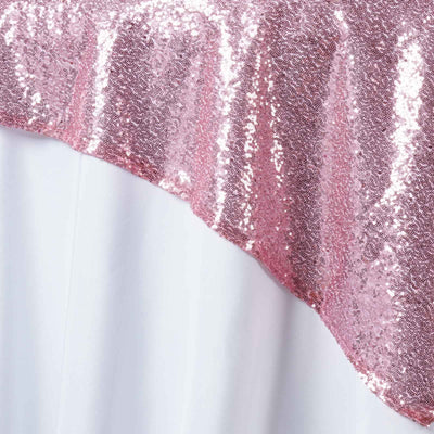 Pink sequin fabric draped elegantly over a white background.