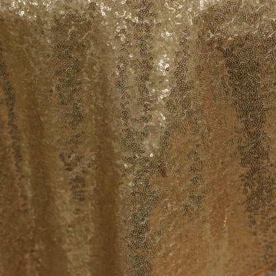 Gold sequin fabric close-up showcasing shimmering texture and detail.