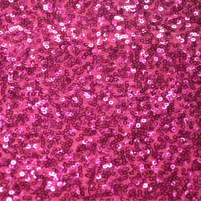 Sparkling pink sequin fabric texture for crafts and decorations.