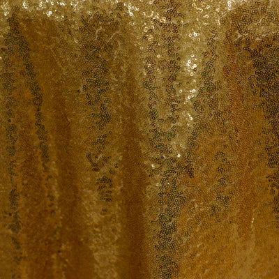 Gold sequin fabric texture close-up shot.