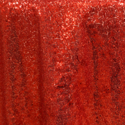 Red sequin fabric texture with a shimmering appearance.